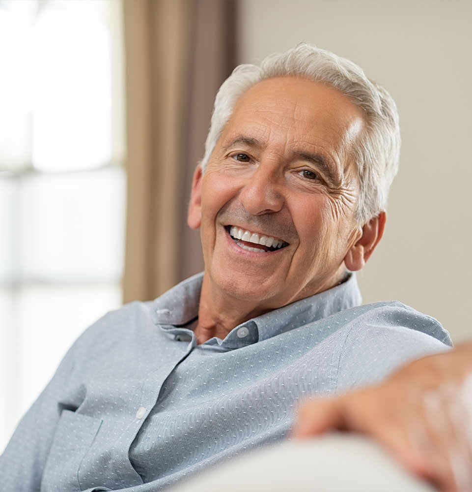mature male smiling in their home